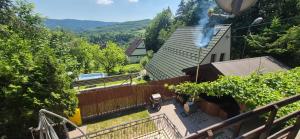a house with smoke coming out of the roof at Leśna Przygoda ,,Balia w cenie" in Harbutowice