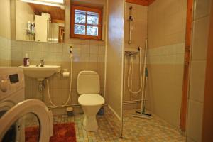 a bathroom with a toilet and a sink at Holidayhome Sompio in Luosto