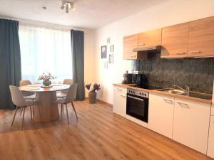 a kitchen with a table and a dining room at Apartments Chloe - Top 1 in Hollabrunn