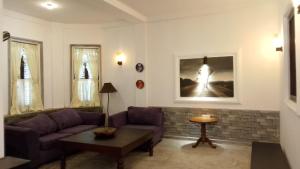a living room with a couch and a table at Pedlar Bungalow in Talpe