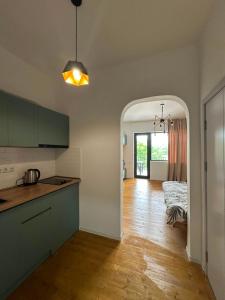 a kitchen with a counter and a table in a room at Bazaleti Lake Family Apartment in Chanadirtkari