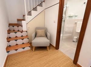 a stairway with a chair next to a bathroom at La Morada Mas Hermosa in Marbella
