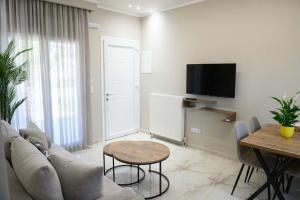 a living room with a couch and a table at Pella Luxury Archonta in Pélla