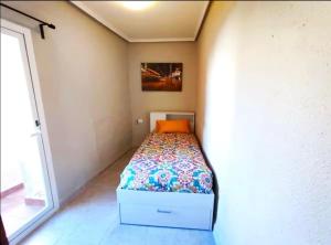 a small bedroom with a bed in a room at Casa reformada centro de Lliria in Lliria