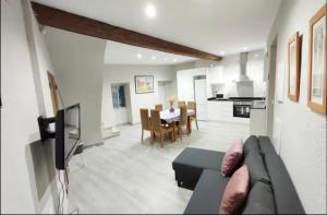 a living room with a couch and a dining room at Casa reformada centro de Lliria in Lliria