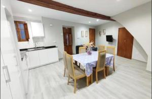 a kitchen and dining room with a table and chairs at Casa reformada centro de Lliria in Lliria +11 photos