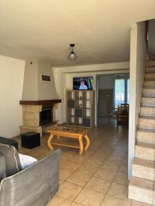 a living room with a table and a fireplace at maison bozouls in Bozouls