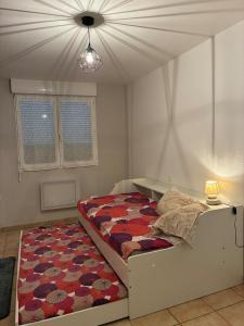 a bedroom with a bed and a ceiling at maison bozouls in Bozouls