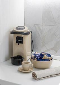 a coffee maker sitting on a counter with a cup of coffee at Home Sisters in Trapani