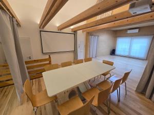 a conference room with a white table and chairs at Wellness apartmán Habánská in Pouzdřany