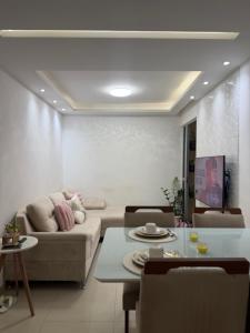 a living room with a couch and a table at Apartamento centro de Paulista-Pe in Paulista