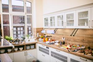 a kitchen with a lot of food on the counter at Johanniterhaus Wittenberg in Lutherstadt Wittenberg +106 photos