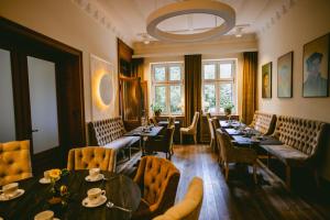 a restaurant with tables and chairs and a large window at Johanniterhaus Wittenberg in Lutherstadt Wittenberg