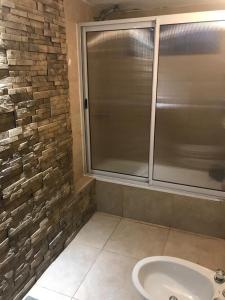 a bathroom with a glass shower and a sink at Posada La Ernestina Villa de las rosas in Villa Las Rosas +52 photos