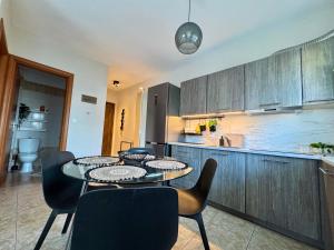 a kitchen with a table and chairs and a counter at Sun Sight - Deluxe Meridian Vista Suites in Pefkochori