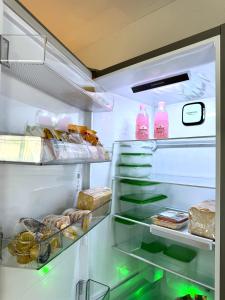 an open refrigerator filled with lots of food at Sun Sight - Deluxe Meridian Vista Suites in Pefkochori +54 photos