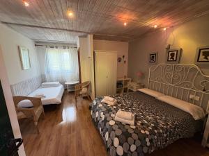 a bedroom with a bed and a room with two beds at Aldea del Trasgu in Cuerres