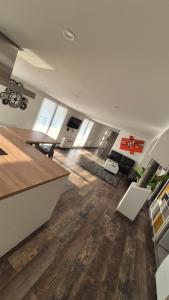 a large living room with wooden floors and white ceilings at ALBI Logement spacieux in Albi +3 photos