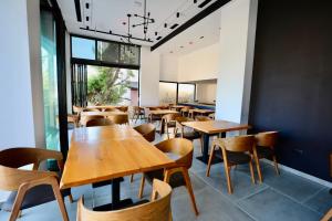 a dining room with wooden tables and chairs at Zeo Hotel Saranda in Sarandë