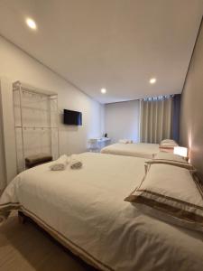 a hotel room with two beds and a television at Andes 97 Guest House in Bogotá