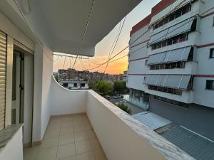 an apartment balcony with a view of a building at Bledis Apartments in Lushnjë