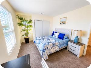 a bedroom with a bed and a plant in it at Route 66 Desert Retreat 3 Bedroom Home With Garden in Victorville