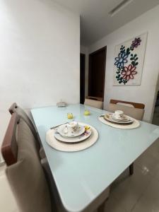 a white table with two plates on top of it at Apartamento centro de Paulista-Pe in Paulista