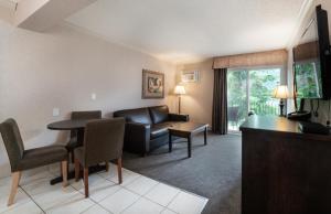 a living room with a couch and a table at Prestige Inn Nelson in Nelson