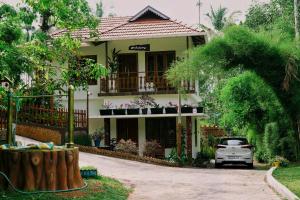 a house with a car parked in front of it at MT'S Villas in Batheri