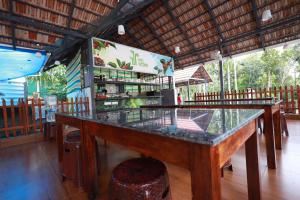 a restaurant with a glass counter in a room at MT'S Villas in Batheri