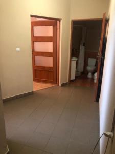 a bathroom with a door and a toilet at Hotel Marianna in Berehove +30 photos