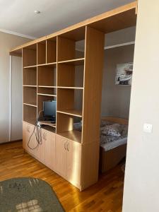 a large wooden book shelf with a bed in it at Hotel Marianna in Berehove