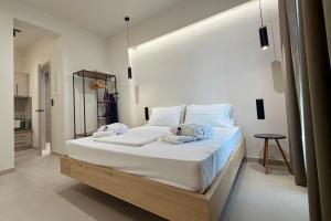 a bedroom with a large bed with towels on it at GLEN Premium Stays in Kanali