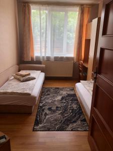 a small room with two beds and a window at Hotel Marianna in Berehove