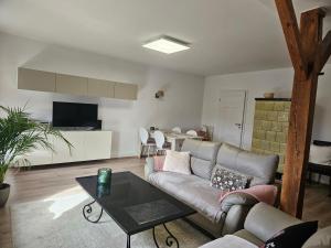 a living room with a couch and a table at Alte Schule Ragow in Ragow