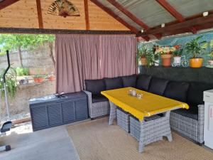 a living room with a couch and a table at Casa Szabo Vata Bai in Vaţa de Jos