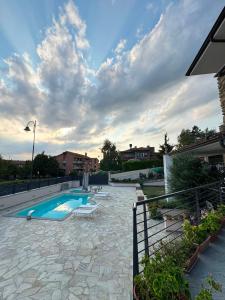 a swimming pool in a yard with a cloudy sky at Villa Seli in Dogliani +24 photos