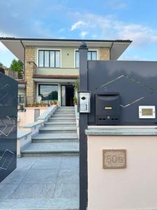 a house with a sign in front of it at Villa Seli in Dogliani