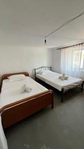 two twin beds in a room with a window at Avdera Holidays apartments in Ávdhira
