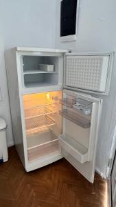 an empty refrigerator with its door open in a room at Avdera Holidays apartments in Ávdhira