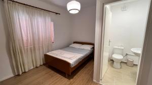 a small bedroom with a bed and a toilet at Avdera Holidays apartments in Ávdhira +45 photos