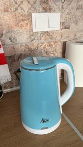 a blue and white tea kettle on a table at Avdera Holidays apartments in Ávdhira