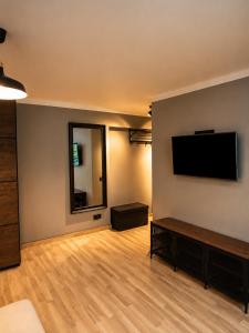 a living room with a flat screen tv on a wall at City Center apartment in Jelgava in Jelgava +4 photos
