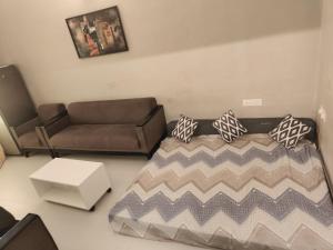 a living room with a couch and a coffee table at Goan Casa Feliz in Calangute +13 photos