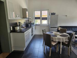 a kitchen and dining room with a table and a table and chairs at Alte Schule Ragow in Ragow +5 photos