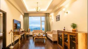 a living room with a couch and a table at The velvet pines in Mukteshwar +11 photos