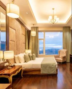 a bedroom with a bed and a large window at The velvet pines in Mukteshwar