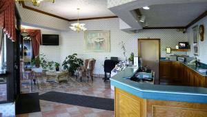 a room with a kitchen and a living room at Magnuson Hotel Howell/Brighton in Howell