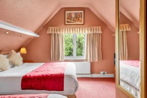 a bedroom with two beds and a window at Seka Inn Hotel in Crowthorne