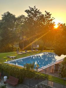 an overhead view of a swimming pool with the sun setting at Quinta do Mosteiro in Felgueiras